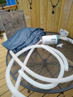 Brand new Intex pool cover for 15x48 pool hoses and cleaner basket for free with cover