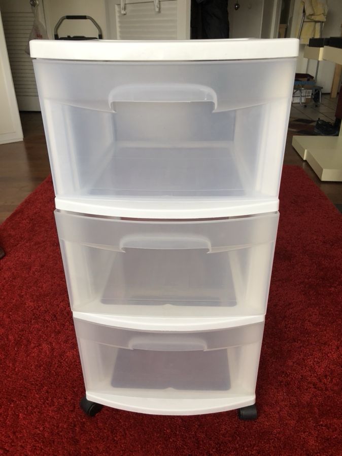 Two plastic 3-drawer storage units with wheels for sale