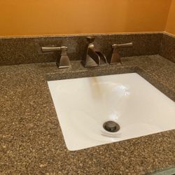 Bathroom sink/faucet With matching light set, toilet paper holder, towel rack and mirror.  