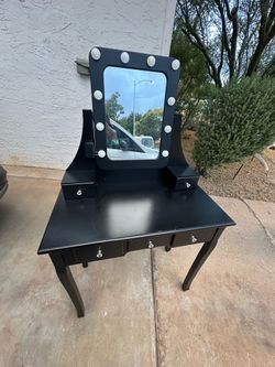 Small black vanity with lights