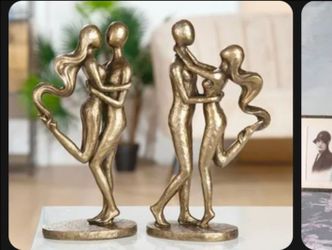 The "Dance of Love" is an intriguing and symbolic bronze-colored sculpture (home decor ) gold tone
