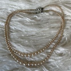 This is a vintage, 1940’s double-strand faux pearl choker necklace with an ornate rhinestone clasp!