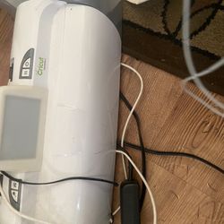 Two Cricut Machines, Large Box Of Permanent Vinyl, Roll Of Vehicle Grade Laminate, Heat Press Tape, Corrugated Cardboard And Much More