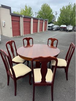 Round wooden table and six chairs