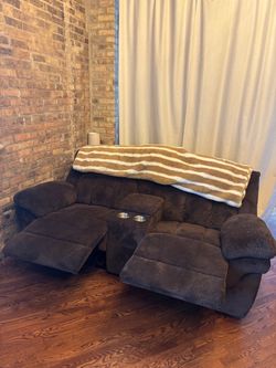 Brown Sofa Couch with power reclining, charging ports, and center council