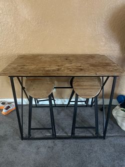 Wooden table with fold in chairs