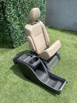 Tan captain seat with black center console