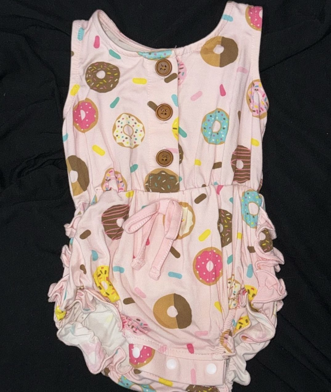 Girls romper with sprinkled donuts with a ruffled butt