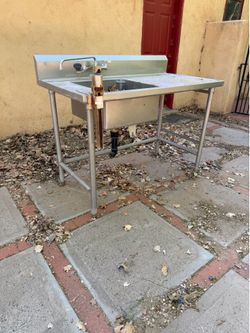 Stainless steel sink with can opener