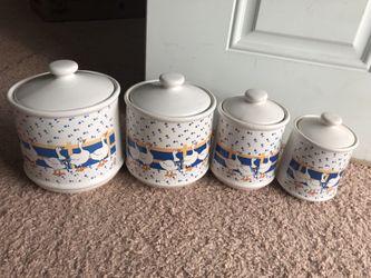 A set of four incredible beautiful docks decorated blue and white with a light brown color cookie jars
