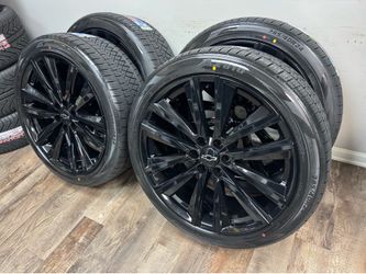 NEW 24 inch gloss black Gm style wheels wrapped in atturo 285/40r24 tires.