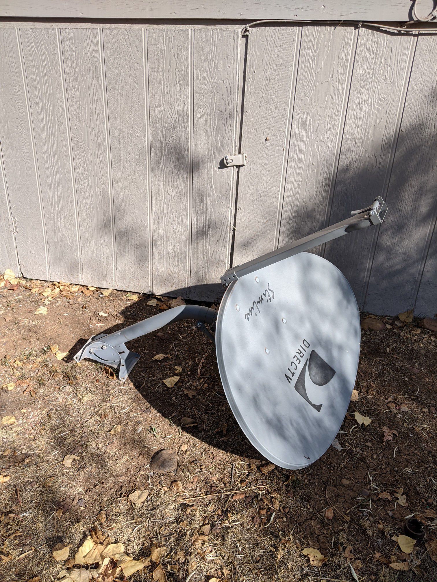Direct TV dish with mounting bracket.