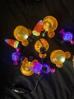 is a Disney Halloween Mickey Mouse pumpkin and candy light-up glow necklace