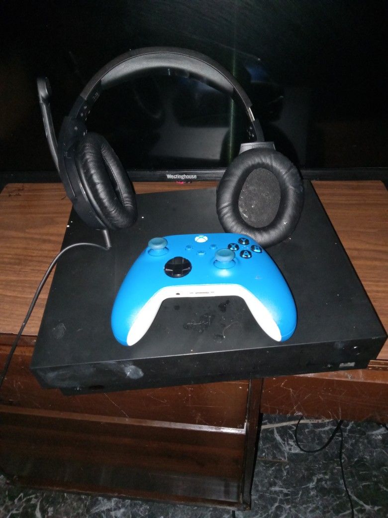 xbox one x with controller and headset