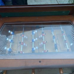 foosball coffee table with a glass top.  