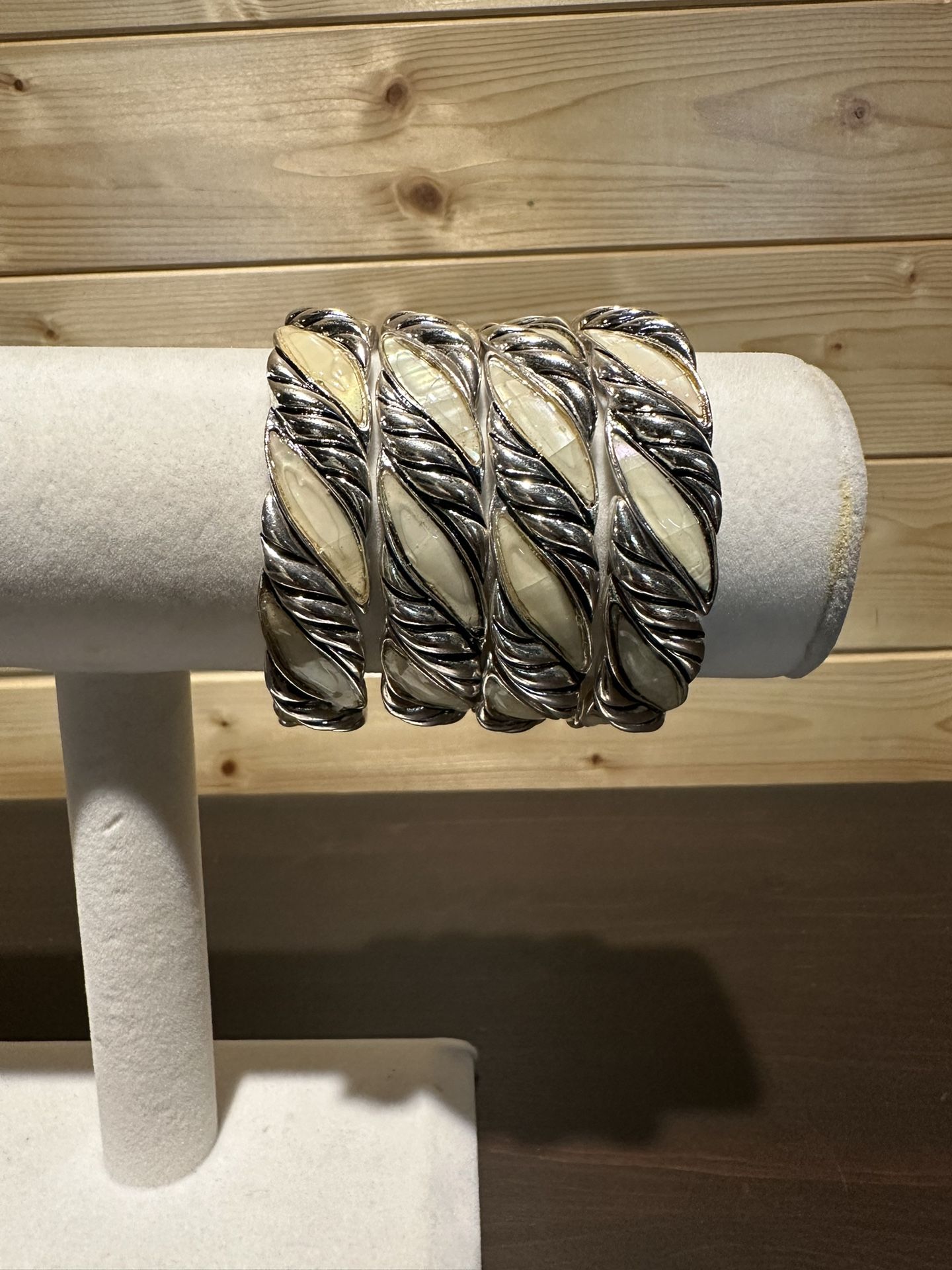 Four stackable ivory and silver stretch bracelets.