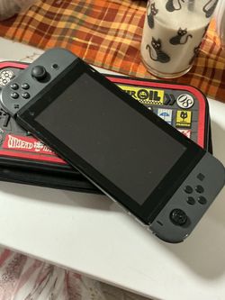 Nintendo switch with case included and a game card of Mario