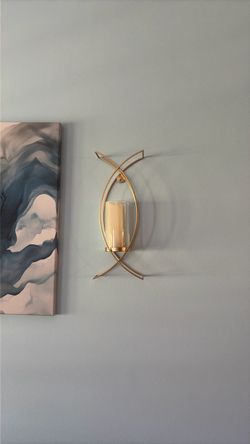 Two gold sconces with candles