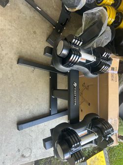 New 25 pound pair of adjustable dumbbells they come with a rack