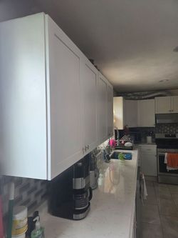 Kitchen cabinets and white marbel counter top