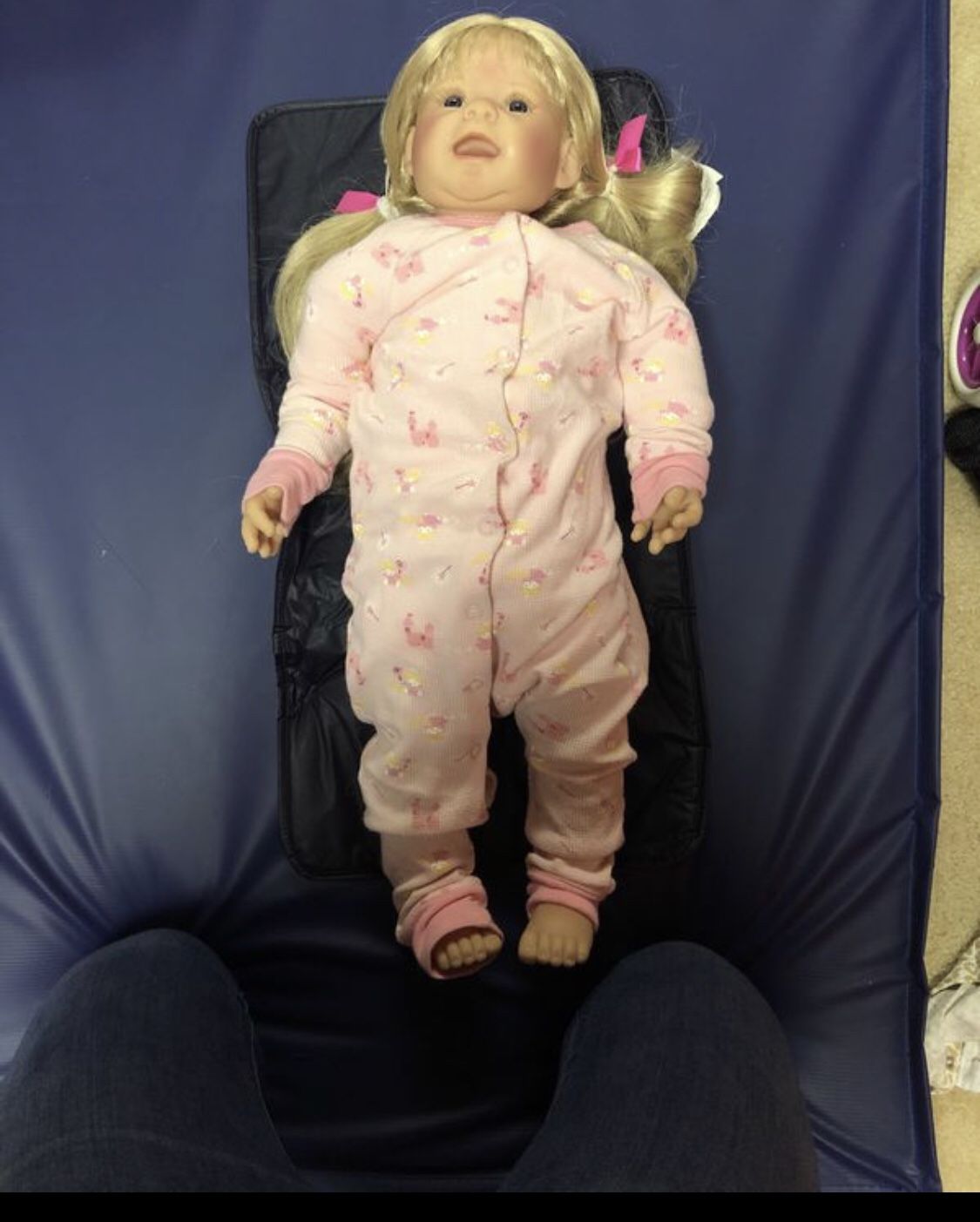 Toddler Doll with suit case full of clothes and a changing mat
