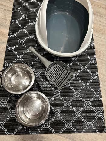 Like New Cat Litter Box with Guard and Spoon $10, Cat Litter Mat $5, Bowls in Metal Stand $8. Less than a month old.