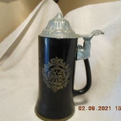 Narrow Lidded Beer Stein with a Crest and "VIP" on one side and a poem on the other side.