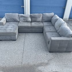 Grey Sectional With Pullout Footrest 