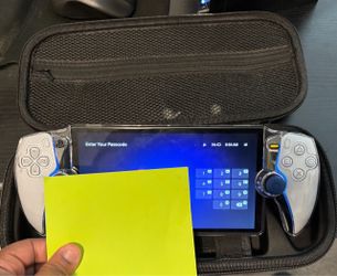 PlayStation Portal with see through hard protective case and black carrying case.