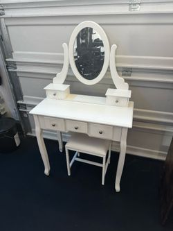 White vanity with mirror and stool