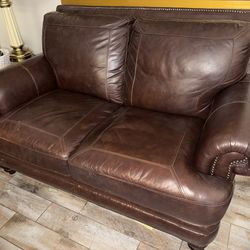 Brown leather loveseat