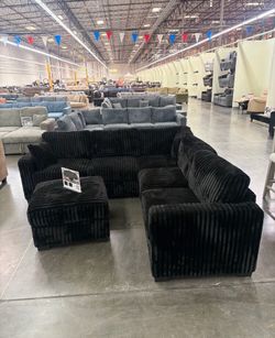 Stylish sectional sofa with ottoman black fur-like jumbo corduroy