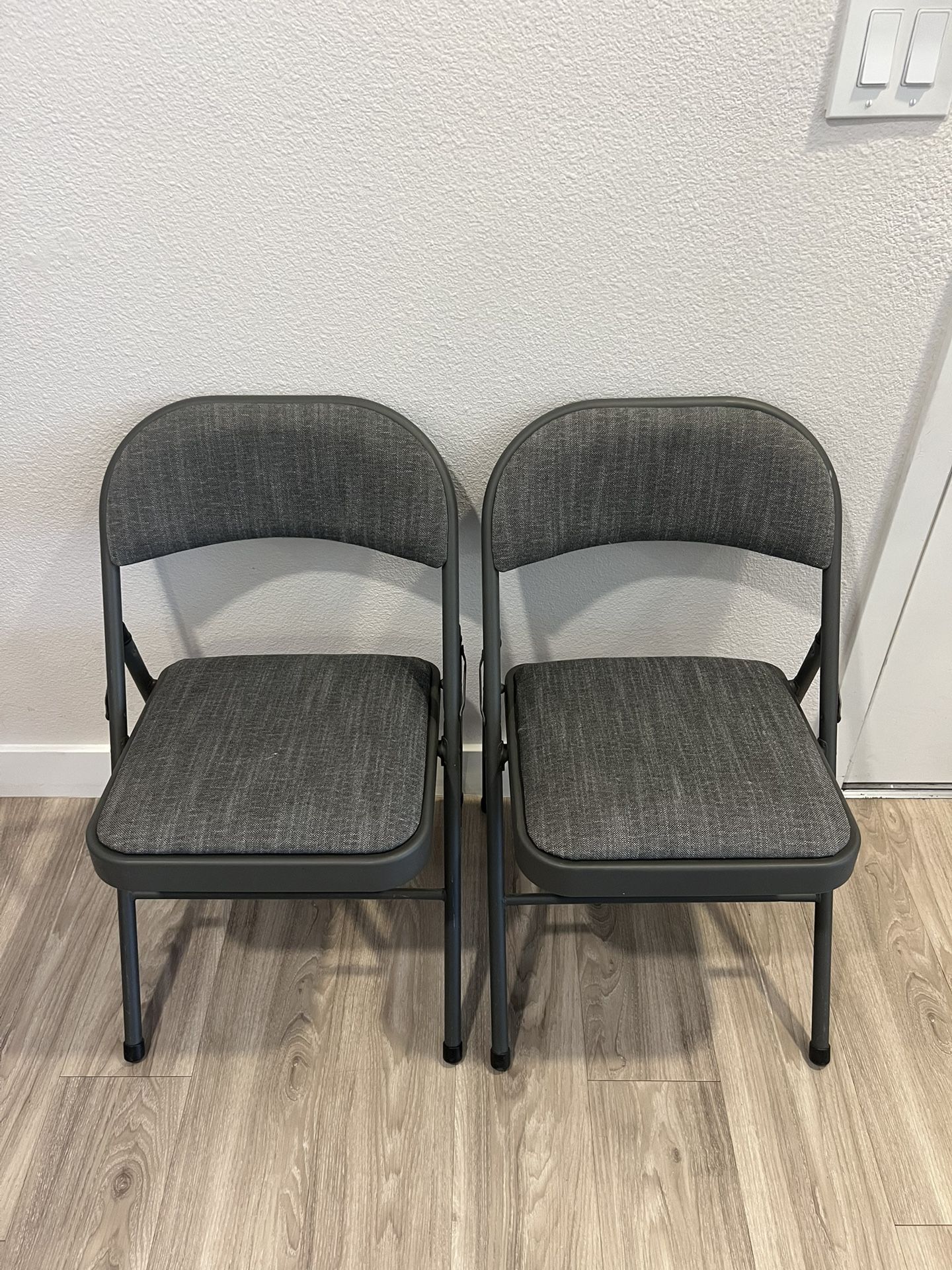 Two Cushioned Folding Chairs
