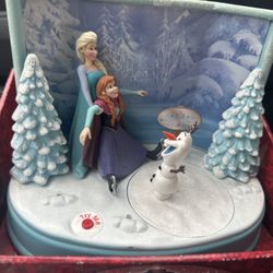 Disney Frozen musical figurine featuring Elsa, Anna, and Olaf.