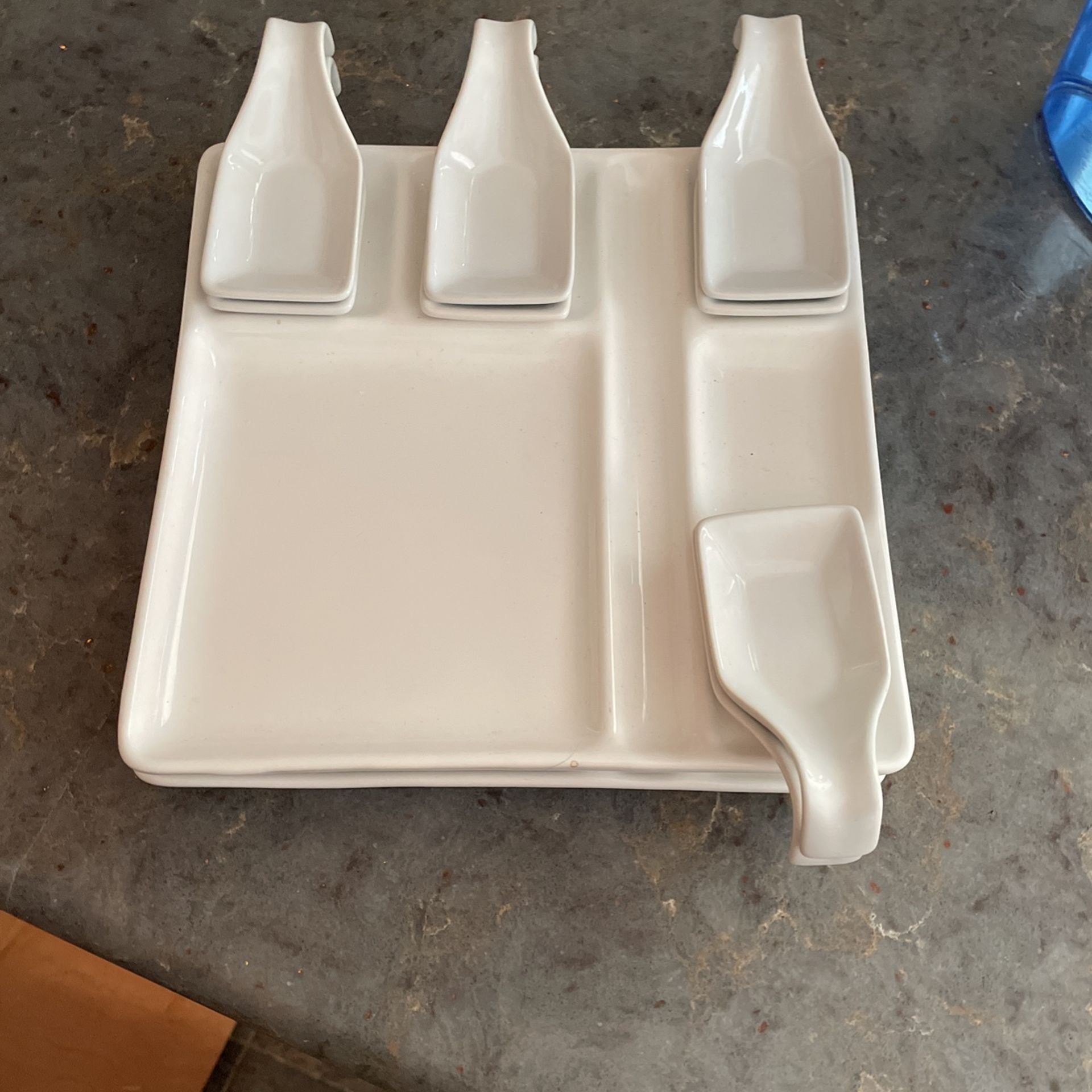 Set of two divided dishes with sauce cups.