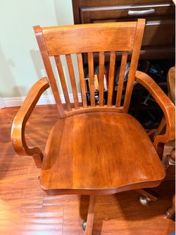 Wooden chair on casters.