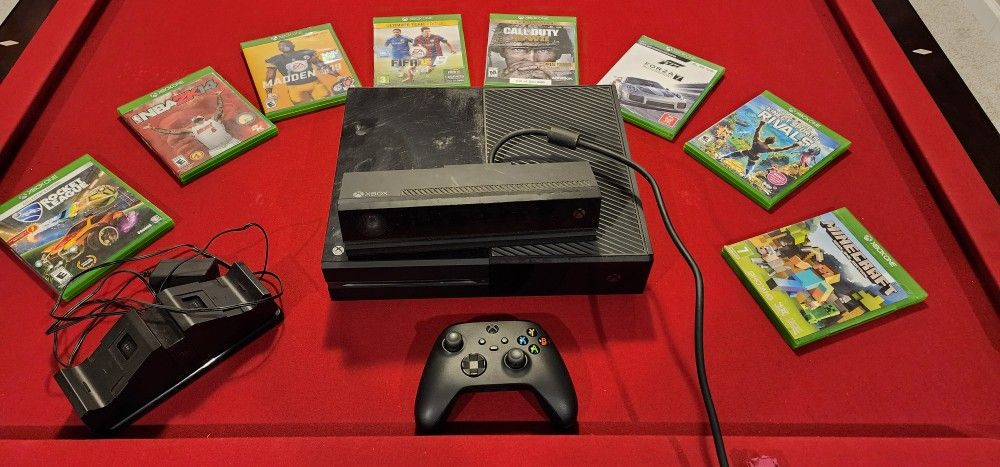 Microsoft Xbox One with Kinect, 1 gaming controller, controller battery & charger stand and 8 Games