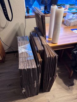 Moving boxes, wrap, and clothes bags