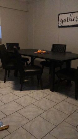 Large brown and black dining table and 6 chairs