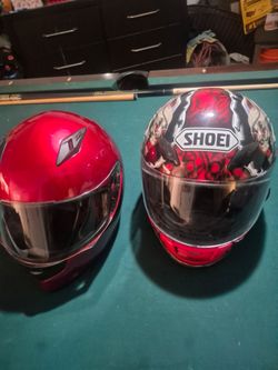2 motorcycle helmets shoei and ilm
