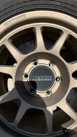 17" Method Race Wheels Bronze w/ 285/70R17 Falken Wildpeak A/T3W Tires (Set of 4)