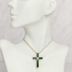 Elegant gold cross pendant necklace featuring deep emerald green 