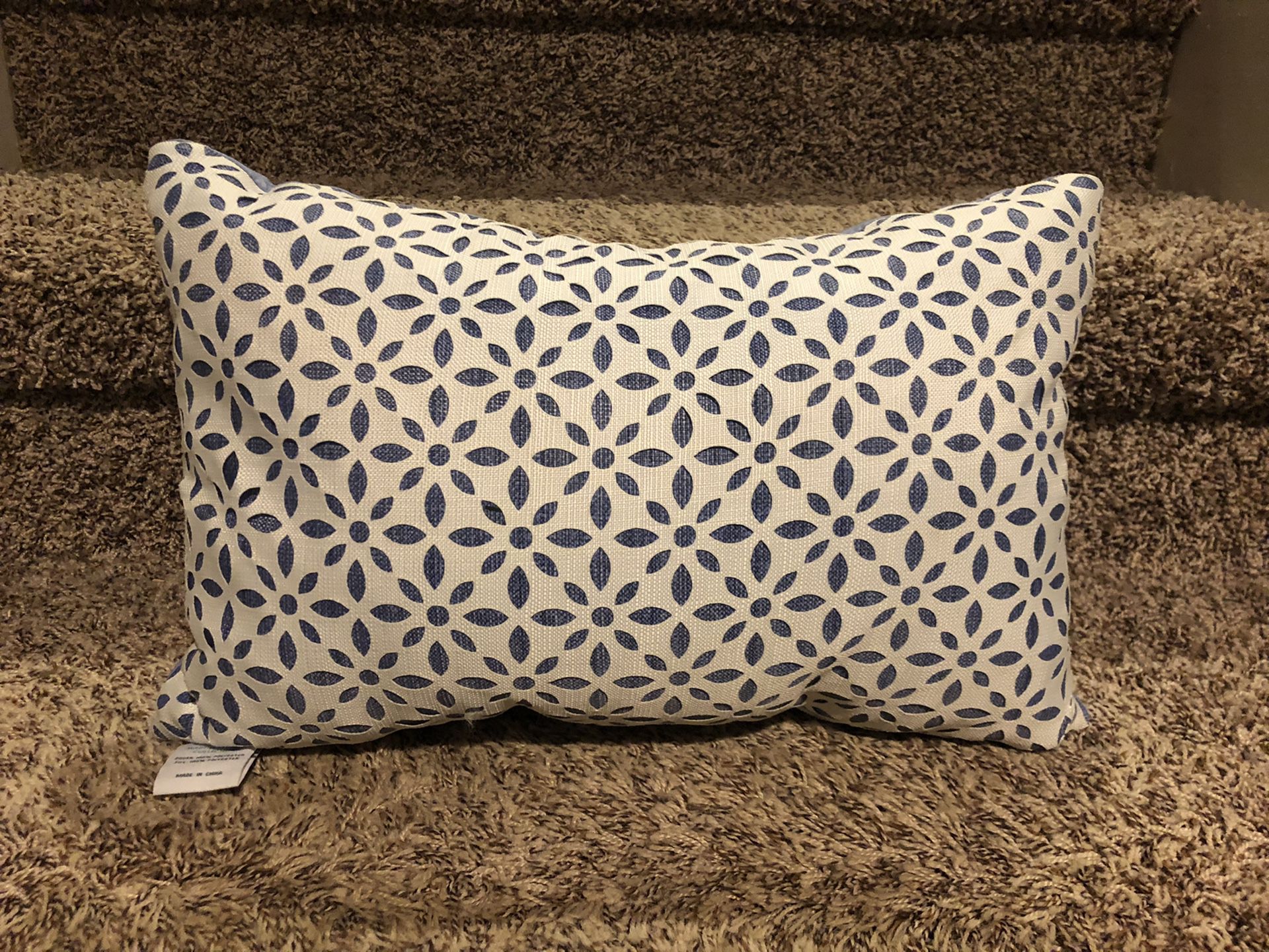 Light blue and white Martha Stewart pillow. Cut outs.