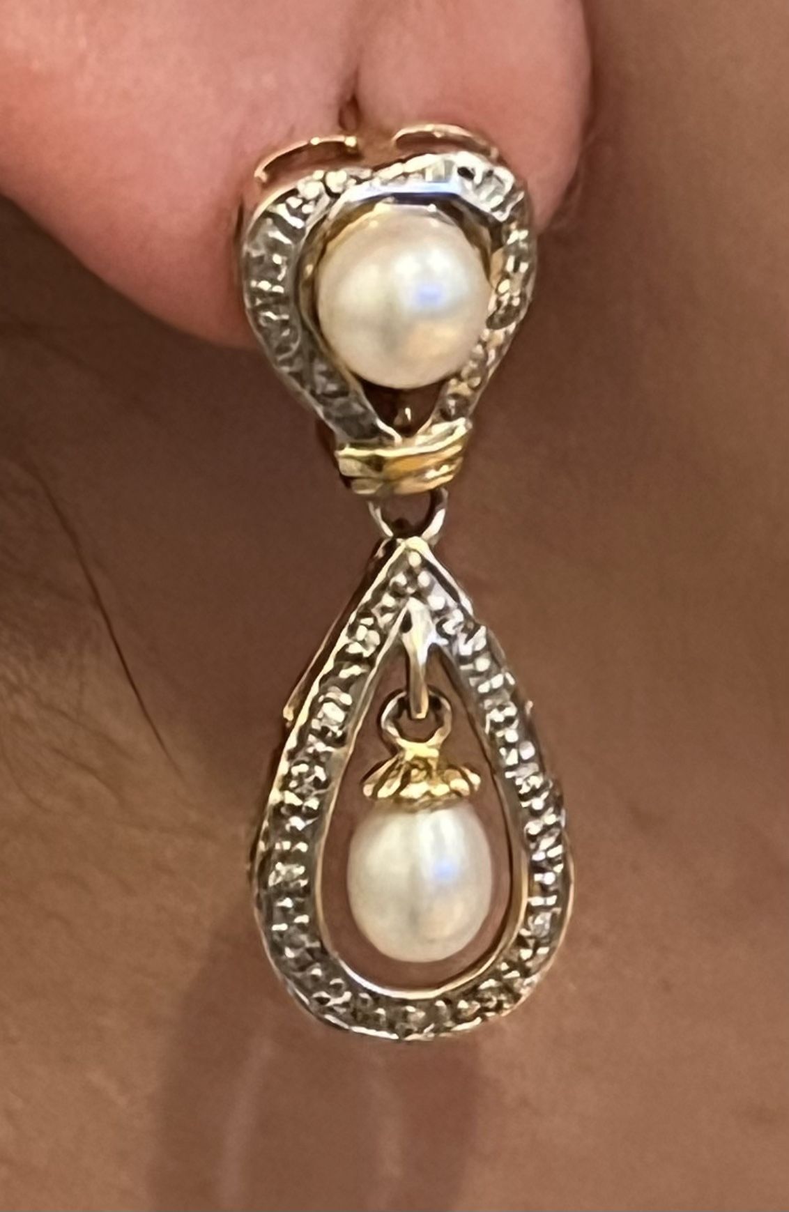 Gold earrings with small diamonds and pearls.
