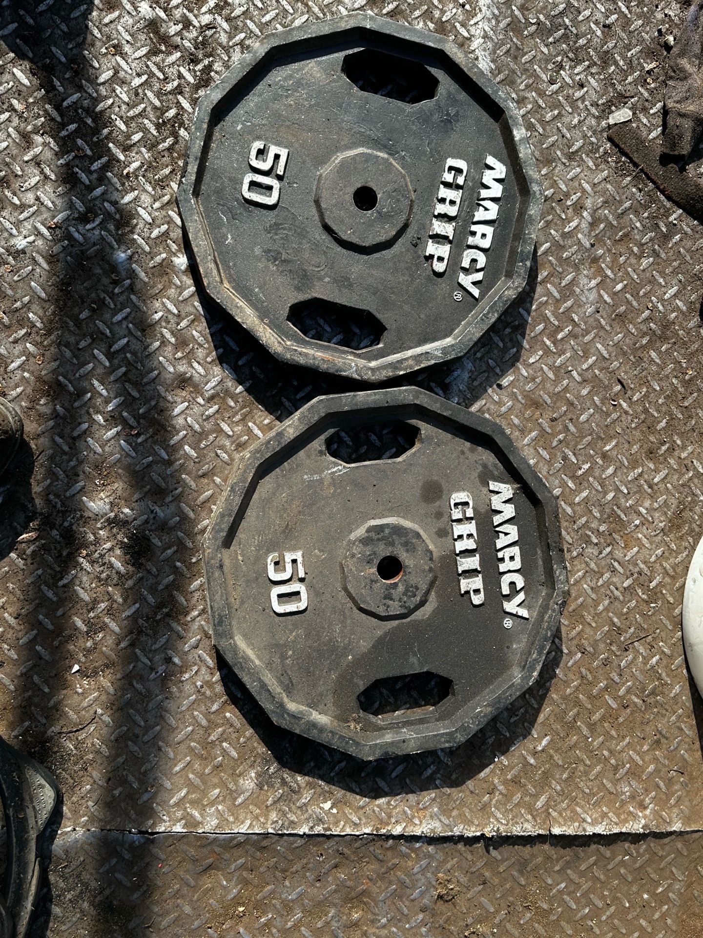 A pair of 50lbs 1inch hole Marcy grip weight plates