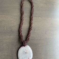 Vintage purple seed bead necklace with a round stone pendant