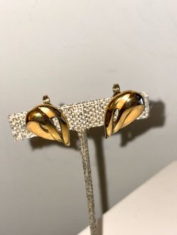 Vintage gold-plated clip-on earrings from the Monet brand, featuring a textured teardrop design.