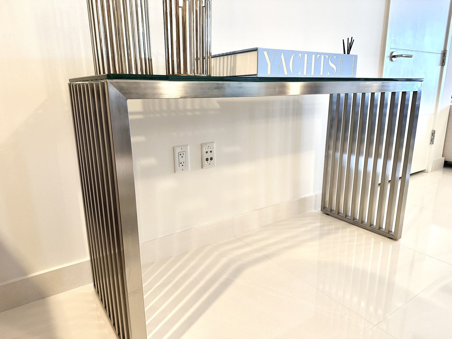 Console table  with continuous Stainless Steel  slats and thick glass top
