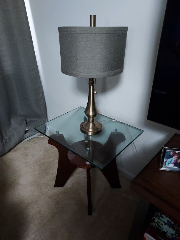 2 wooden table with glass top and 2 rustic bronze finish lamps
