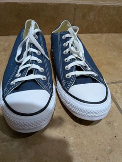 Size 10 Converse Chuck Taylor All Star low top sneakers featuring white laces and a white rubber toe cap.